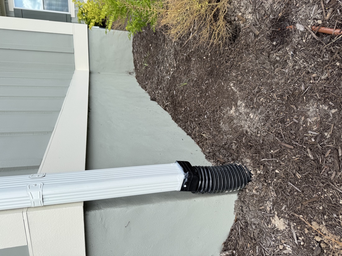 Downspout connected to an underground drain line